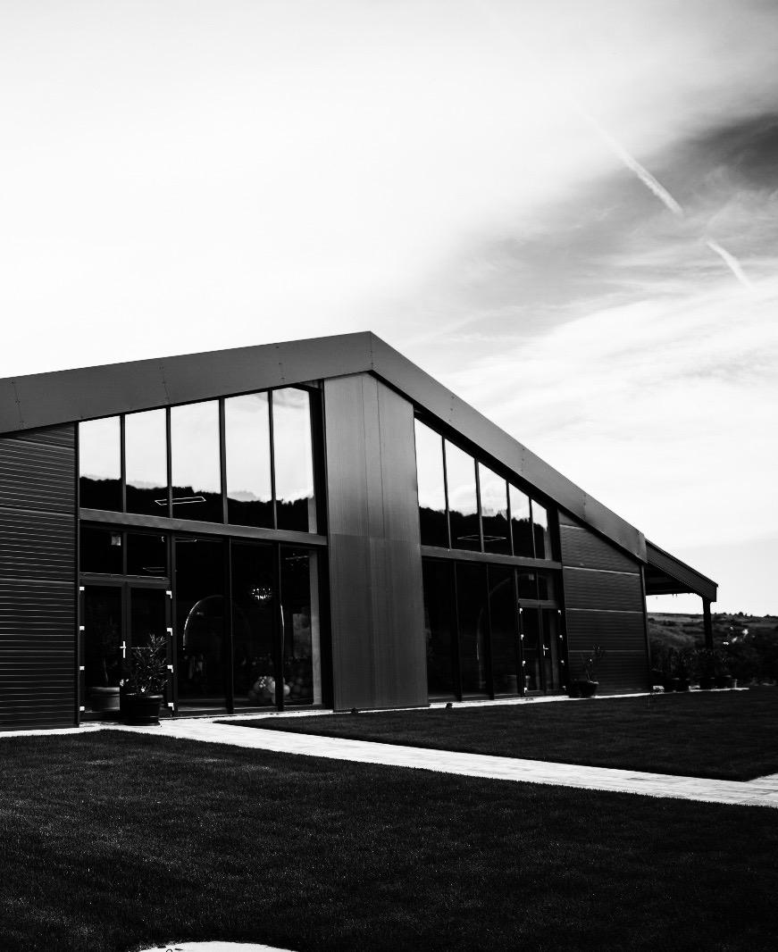 Close-up of a person wearing a white dress and white high-heeled shoes.